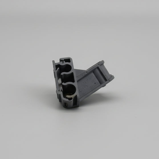 Small mechanical part on a surface with printed text and logos