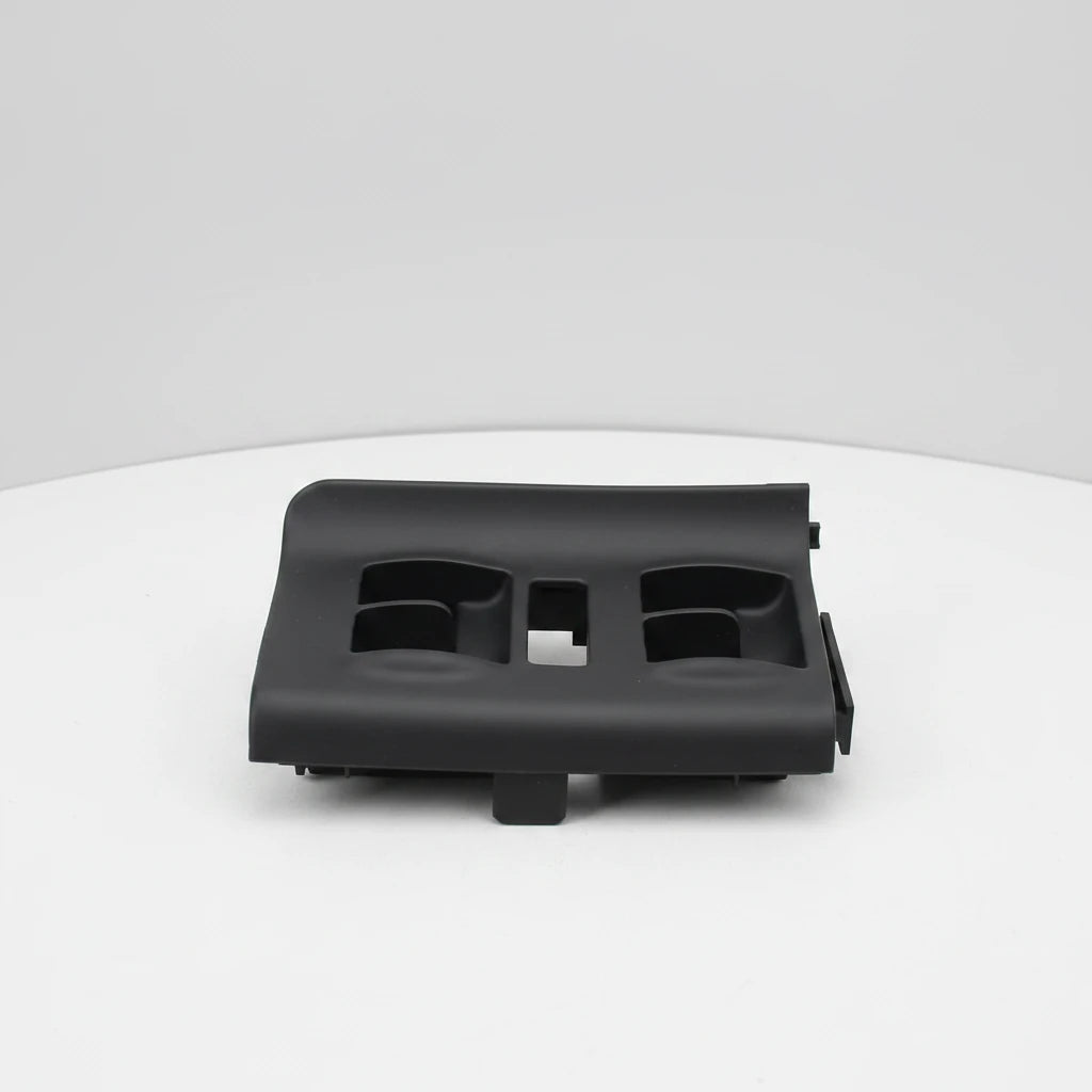 A black plastic automotive trim piece or dashboard component, photographed on a clean white background with a small ECS Tuning watermark in the bottom right corner.